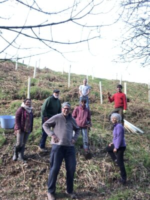 B2Z directors Phil Furneaux and Michelle Rae planting trees with volunteers as part of the biodiversity programme.