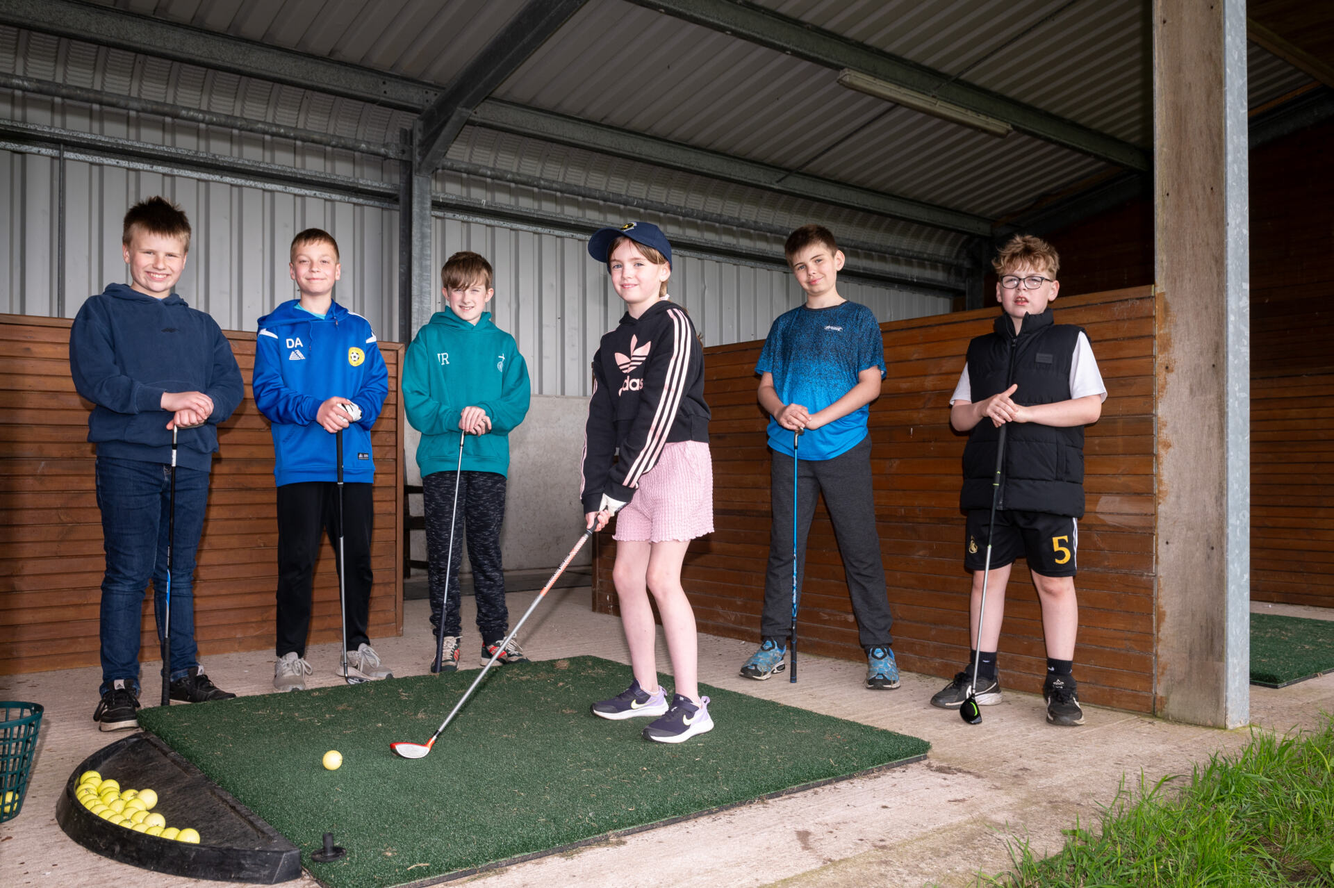 PLAY IT FORWARD PENRITH GOLF --- Fibrus' Play It Forward Fund has bought new mats for Penrith Golf Club Junior Academy. Images of golfers at the club practicing around the new mats.