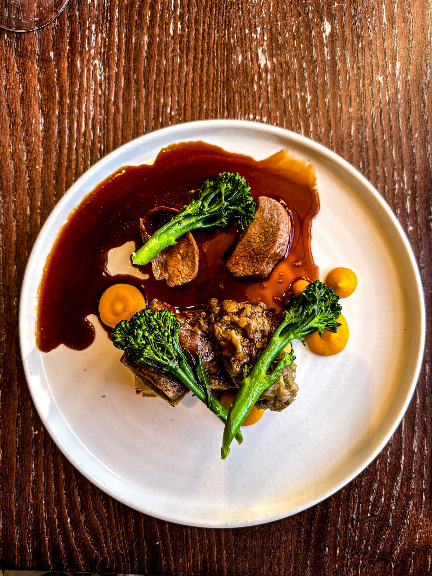 Main course -Roast English Lamb Loin with confit belly, dauphinoise, aubergine, purple spouting broccoli and lamb jus 