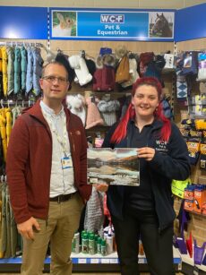 Alex Groves from Eden Valley Hospice and Hannah Muirhead, store manager of WCF Pet & Equestrian in Carlisle, with the charity’s 2025 calendar