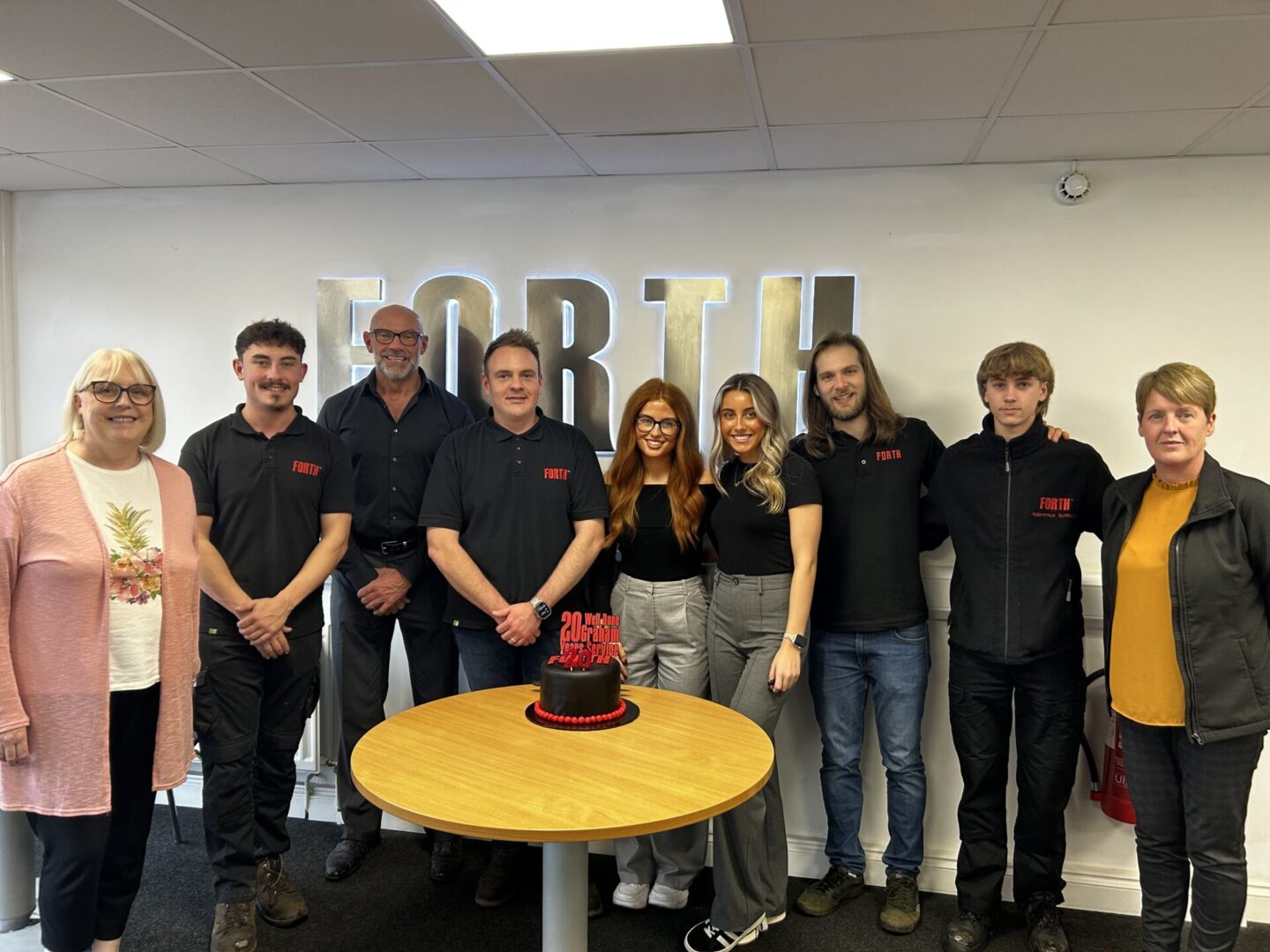 Graham Cartwright and members of the Forth team celebrate his work anniversary with a specially made cake